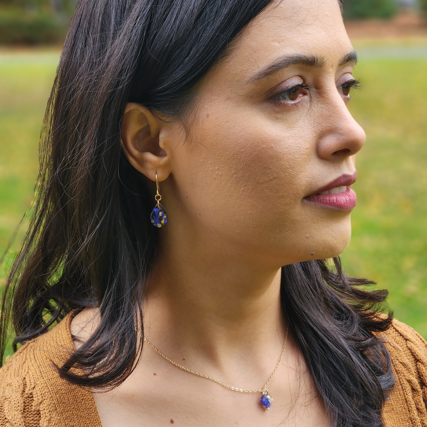 Cornflower Teardrop Earrings on ears, resin earrings, model image